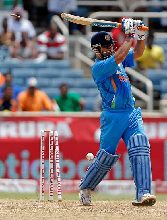 Mahendra Singh Dhoni is bowled by West Indies' Tino Best for 27 runs during their Tri-Nation Series cricket match in Kingston, Jamaica.