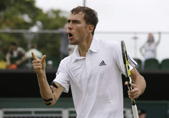 Jerzy Janowicz of Poland reacts after winning a point against Jurgen Melzer of Austria during their Men's singles match at the All England Lawn Tennis Championships in Wimbledon.