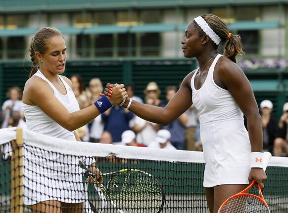 Sloane Stephens of the United States, right, greets Monica Puig of Puerto Rico at the net after winning their Women's singles match at the All England Lawn Tennis Championships in Wimbledon, London.