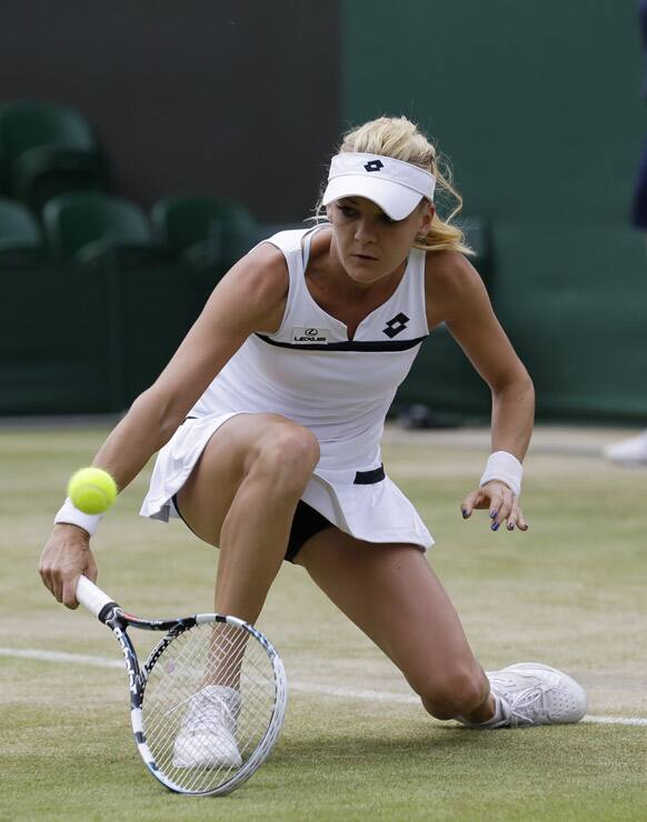 Agnieszka Radwanska of Poland returns to Tsvetana Pironkova of Bulgaria during their Women's singles match at the All England Lawn Tennis Championships in Wimbledon, London.