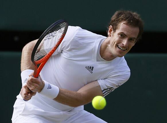 Andy Murray of Britain plays a return to Mikhail Youzhny of Russia in a Men's singles match at the All England Lawn Tennis Championships in Wimbledon, London.