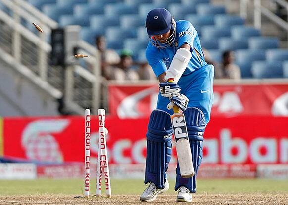 India's Umesh Yadav is bowled by Sri Lanka's Lasith Malinga for a duck during their Tri-Nation Series cricket match in Kingston, Jamaica. Sri Lanka won by 161 runs.