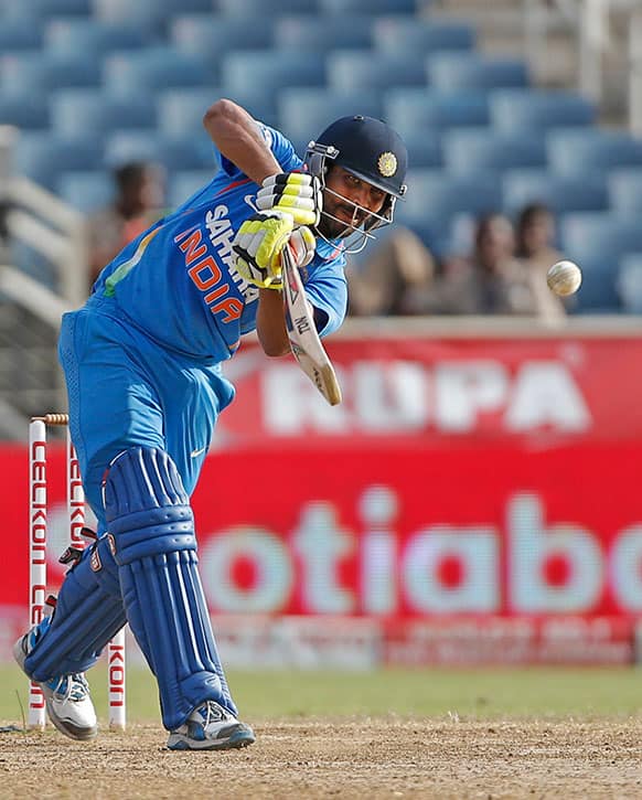 India's Ravindra Jadeja drives a delivery off Sri Lanka's Lasith Malinga during their Tri-Nation Series cricket match in Kingston, Jamaica.