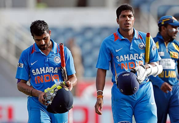 India two last batsmen Ravindra Jadeja, left, and Umesh Yadav walk off the pitch after loosing to Sri Lanka in their Tri-Nation Series cricket match in Kingston, Jamaica. Sri Lanka won by 161 runs.