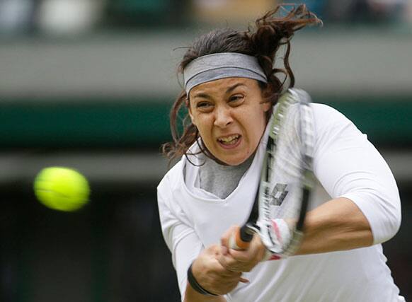 Marion Bartoli of France plays a return to Sloane Stephens of the United States during their Women's singles quarterfinal match at the All England Lawn Tennis Championships in Wimbledon.