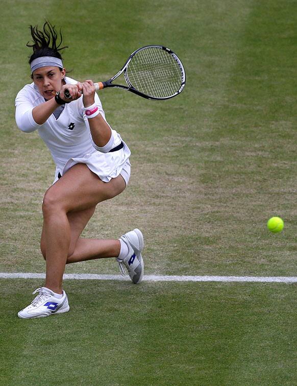 Marion Bartoli of France returns to Sloane Stephens of the United States during their Women's singles quarterfinal match at the All England Lawn Tennis Championships in Wimbledon.