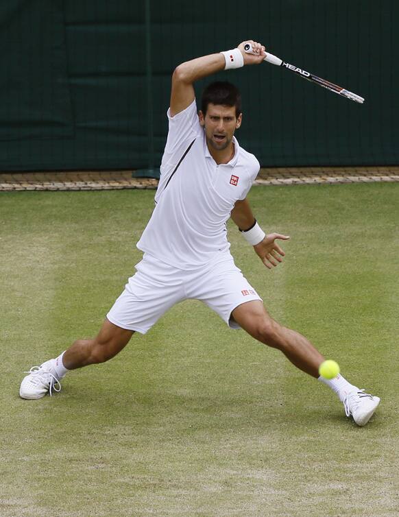 Novak Djokovic of Serbia plays a return to Tomas Berdych of the Czech Republic during a Men's singles quarterfinal match at the All England Lawn Tennis Championships in Wimbledon, London.