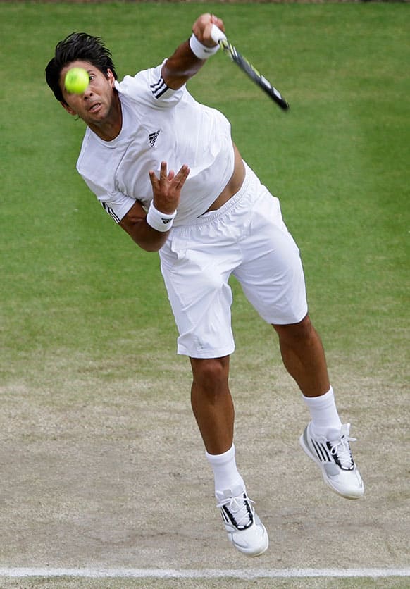 Fernando Verdasco of Spain serves to Andy Murray of Britain during their Men's singles quarterfinal match at the All England Lawn Tennis Championships in Wimbledon.