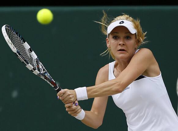 Agnieszka Radwanska of Poland plays a return to Sabine Lisicki of Germany during their Women's singles semifinal match at the All England Lawn Tennis Championships in Wimbledon.