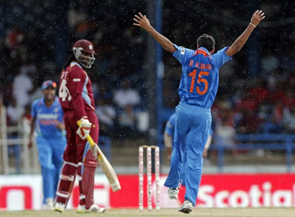 Bhuvneshwar Kumar (15) celebrates after taking the wicket of West Indies opening batsman Chris Gayle, who was caught behind for 10 runs, during their Tri-Nation Series cricket match in Port-of-Spain, Trinidad.