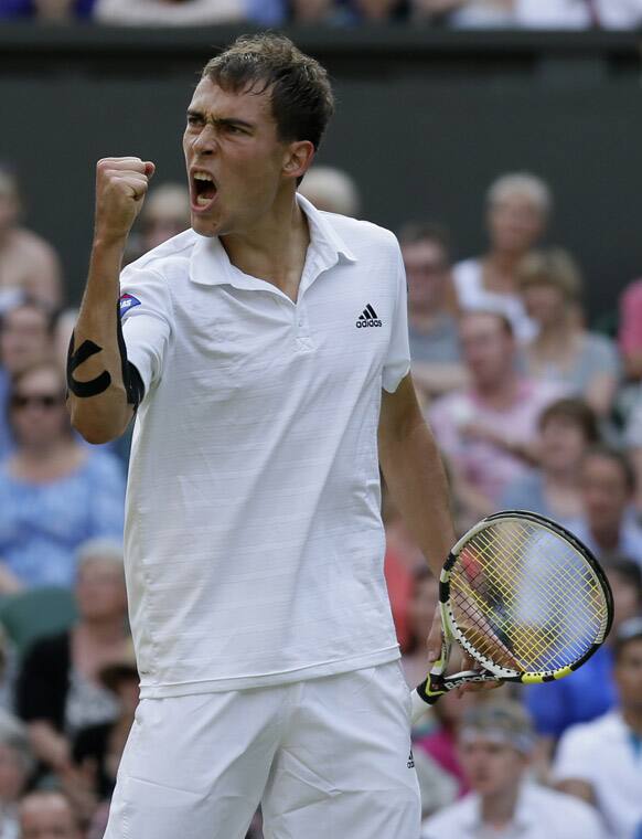 Jerzy Janowicz of Poland reacts after winning a point against Andy Murray of Britain during their Men's singles semifinal match at the All England Lawn Tennis Championships in Wimbledon.