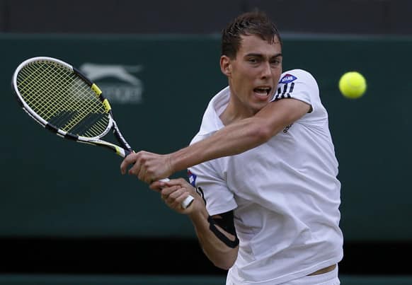 Jerzy Janowicz of Poland returns to Andy Murray of Britain during their Men's singles semifinal match at the All England Lawn Tennis Championships in Wimbledon.