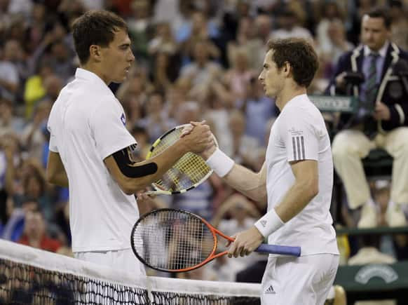 Andy Murray of Britain, right, greets Jerzy Janowicz of Poland at the net after winning their Men's singles semifinal match at the All England Lawn Tennis Championships in Wimbledon.