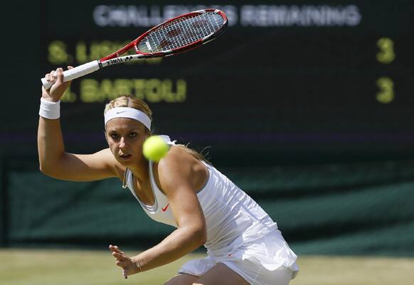 Sabine Lisicki of Germany plays a return to Marion Bartoli of France during their Women's singles final match at the All England Lawn Tennis Championships in Wimbledon, London.