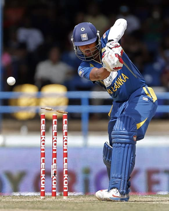 Sri Lanka's Dinesh Chandimal is bowled by West Indies' Kemar Roach for 2 runs during their Tri-Nation Series cricket match in Port-of-Spain.