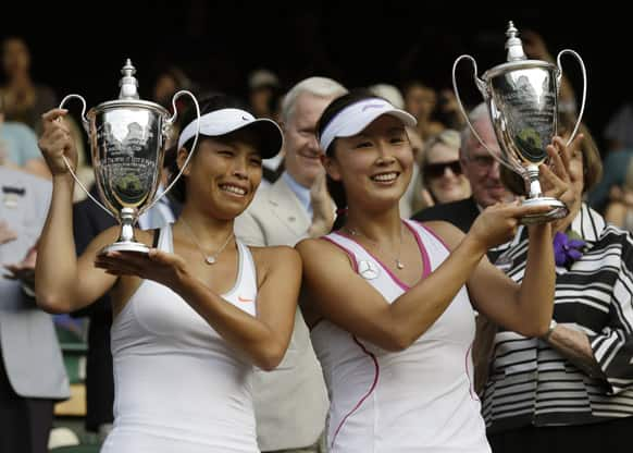 Su-Wei Hsieh of Taiwan, left, and Shuai Peng of China pose with their trophies after winning against Ashleigh Barty of Australia and Casey Dellacqua of Australia in the Women's doubles final match at the All England Lawn Tennis Championships.