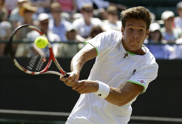 Gianluigi Quinzi of Italy plays a shot to Hyeon Chung of South Korea during the Boys' singles final match at the All England Lawn Tennis Championships in Wimbledon.