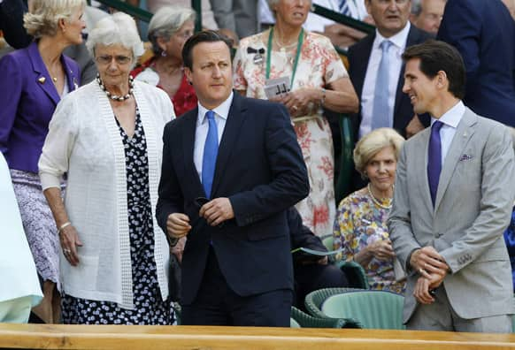 Britain's Prime Minister David Cameron, center, and his mother Mary arrive to watch Andy Murray of Britain face Novak Djokovic of Serbia in the Men's singles final match at the All England Lawn Tennis Championships in Wimbledon.