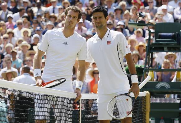 Andy Murray of Britain, left, and Novak Djokovic of Serbia pose for photographers at the net before the Men's singles final match at the All England Lawn Tennis Championships in Wimbledon, London.