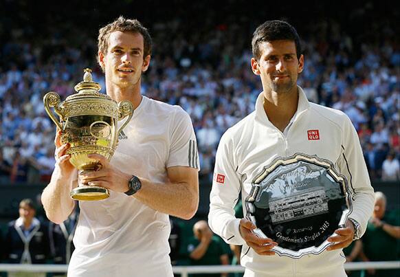 Andy Murray of Britain poses with the trophy alongside Novak Djokovic of Serbia after he won the Men's singles final match at the All England Lawn Tennis Championships in Wimbledon.