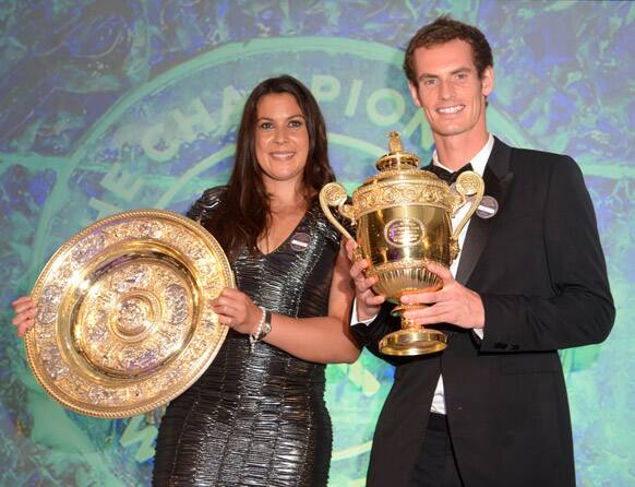 Men's singles champion Britain's Andy Murray and Women's singles champion France's Marion Bartoli pose with their trophies during the Wimbledon tennis Champions Ball in London.