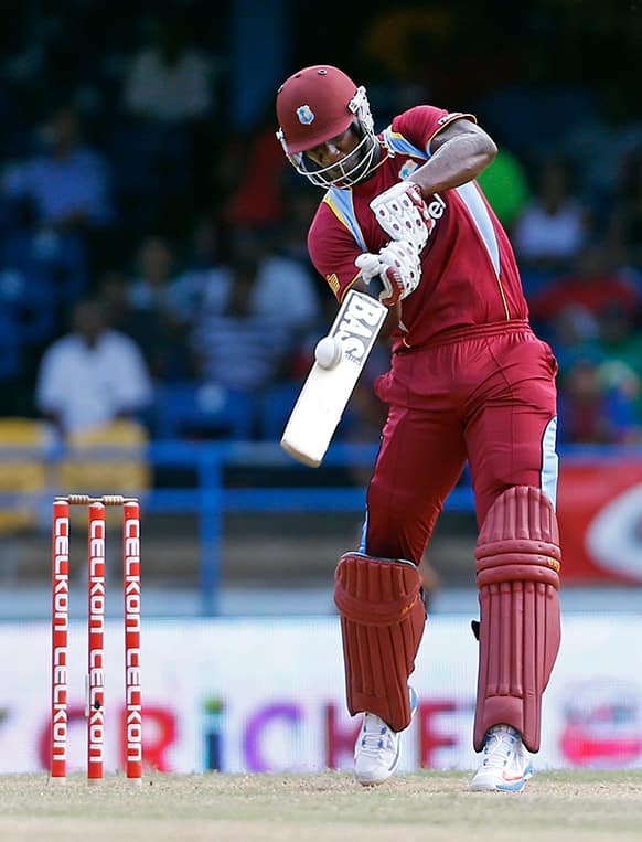 West Indies' Darren Sammy drives a delivery off Sri Lanka's Lasith Malinga to be caught out for three runs during their Tri-Nation Series cricket match in Port-of-Spain, Trinidad.