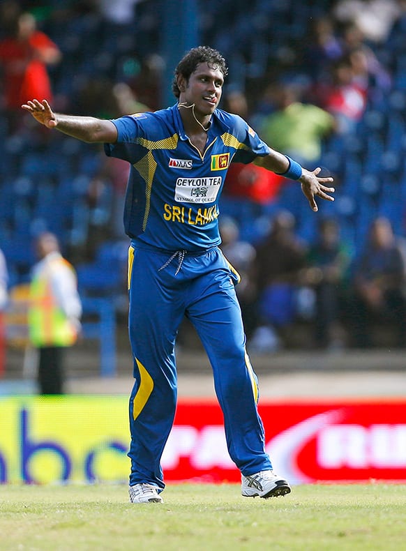 Sri Lanka captain Angelo Mathews celebrates after bowling out West Indies' Jason Holder for a duck during their Tri-Nation Series cricket match in Port-of-Spain, Trinidad.