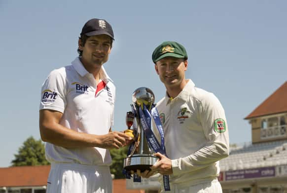 England's captain Alastair Cook and Australia captain Michael Clarke pose for pictures with a replica of the Ashes urn, left, and the series trophy the day before the opening Ashes cricket match at Trent Bridge cricket ground, Nottingham.