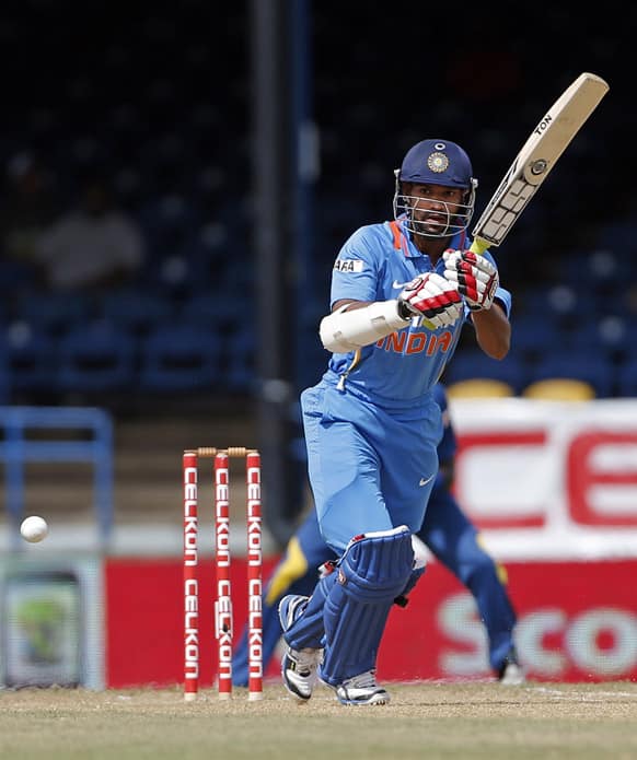 Shikhar Dhawan plays a shot off Sri Lanka bowler Dilhara Lokuhettige during their Tri-Nation Series cricket match in Port-of-Spain, Trinidad.