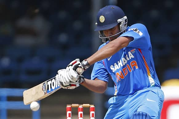 Rohit Sharma drives a delivery off Sri Lanka's Dilhara Lokuhettige during their Tri-Nation Series cricket match in Port-of-Spain.