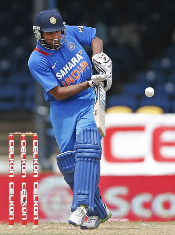 Rohit Sharma drives a delivery off Sri Lanka's Dilhara Lokuhettige during their Tri-Nation Series cricket match in Port-of-Spain, Trinidad.