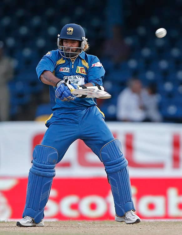 Sri Lanka's Lasith Malinga drives a delivery off India's Umesh Yadav to be caught by Ravindra Jadeja for seven runs during their Tri-Nation Series cricket match in Port-of-Spain, Trinidad.