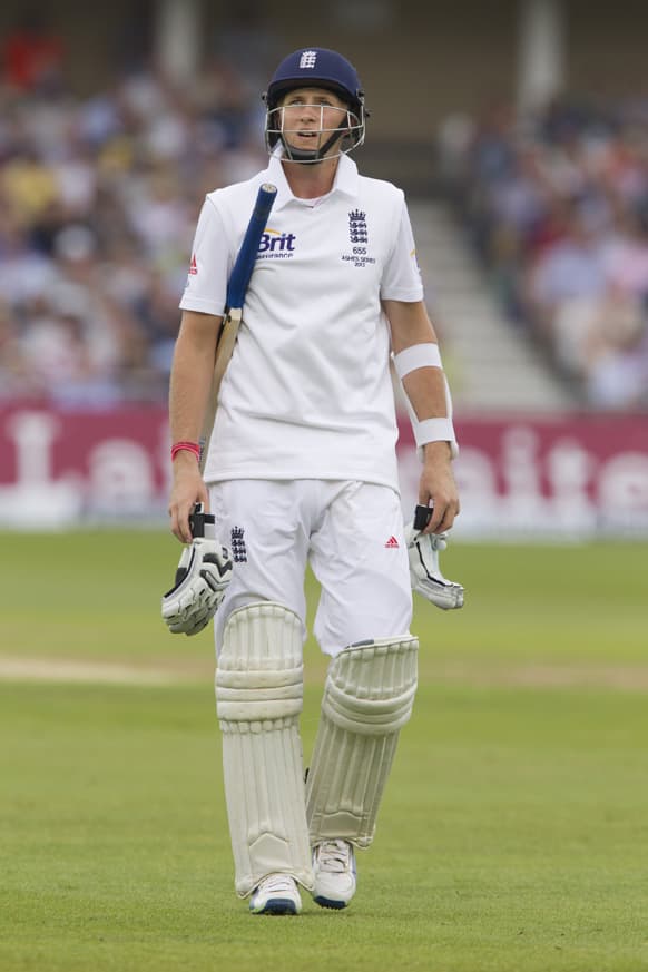 England's Joe Root walks from the pitch after losing his wicket for 30 bowled by Australia's Peter Siddle during the first day of the opening Ashes series cricket match against at Trent Bridge cricket ground, Nottingham, England.