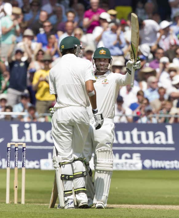 Australia's Phillip Hughes raises hits bat as he reaches a half-century on the second day of the opening Ashes series cricket match against England at Trent Bridge cricket ground, Nottingham, England.