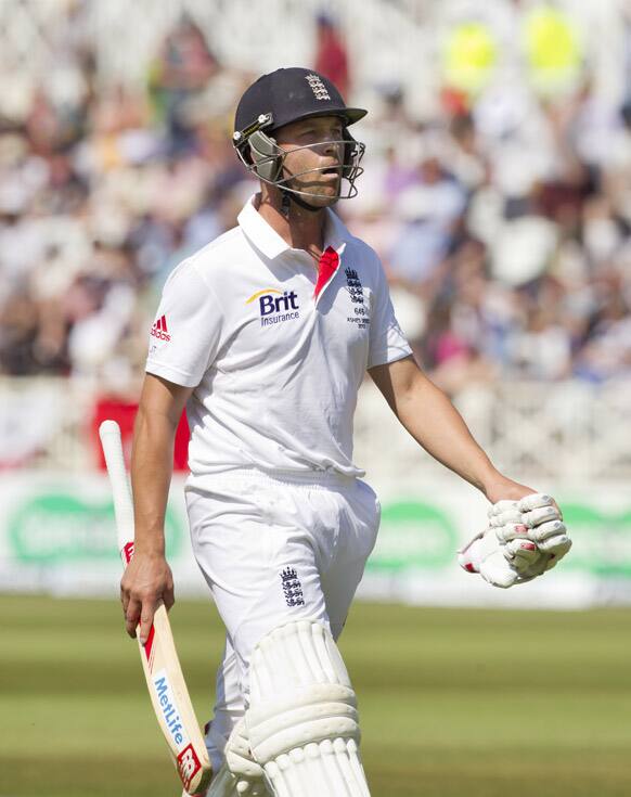 England's Jonathan Trott walks from the pitch after controversially losing his wicket LBW first ball off the bowling Australia's Mitchell Starc on the second day of the opening Ashes series cricket match at Trent Bridge cricket ground, Nottingham, England.