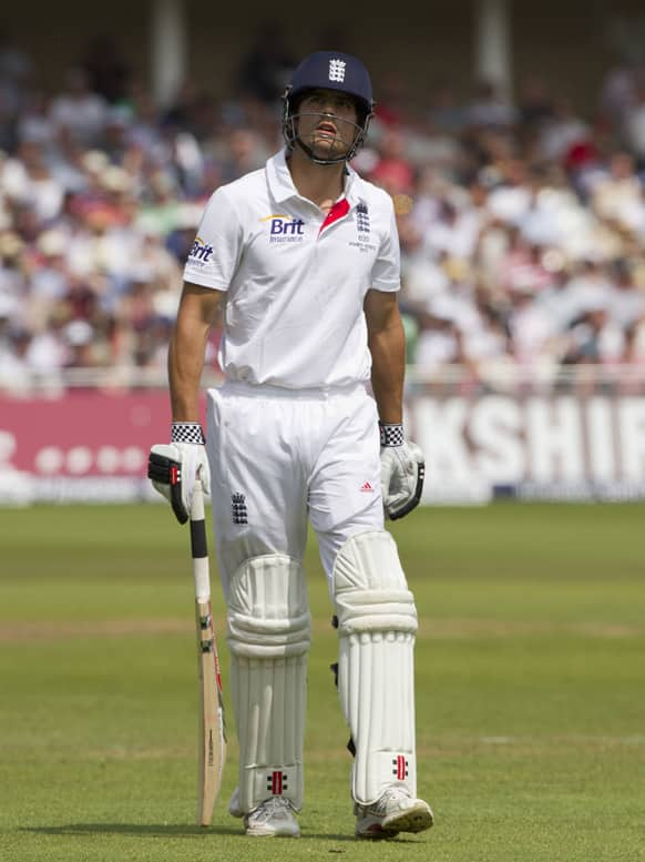 England Alastair Cook walks from the pitch after losing his wicket for 50 caught by Australia's Michael Clarke off the bowling of Ashton Agar on the third day of the opening Ashes series cricket match against at Trent Bridge cricket ground, Nottingham, England.