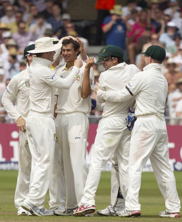 Australia's Ashton Agar celebrates with teammates after taking the wicket of England's Jonny Bairstow caught on 15 by Brad Haddin, on the third day of the opening Ashes series cricket match at Trent Bridge cricket ground, Nottingham, England.