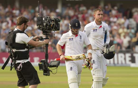 England's Stuart Broad, right, and Ian Bell walk from the pitch at stumps at close of play after the third day of the opening Ashes series cricket match against Australia at Trent Bridge cricket ground, Nottingham.