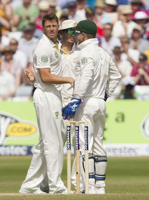 Australia's James Pattinson, left, celebrates with teammates after taking the wicket of England's Stuart Broad for 65, caught by Brad Haddin, right, on the fourth day of the opening Ashes series cricket match at Trent Bridge cricket ground, Nottingham.