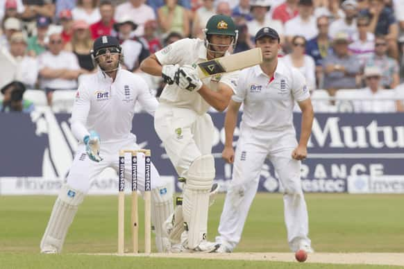 Australia's Ashton Agar, centre, plays a shot off the bowling of England's Graeme Swann on the final day of the opening Ashes series cricket match at Trent Bridge cricket ground, Nottingham.