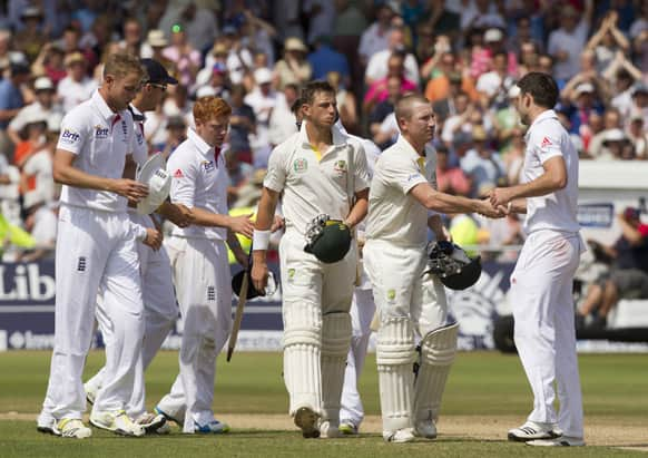 England's James Anderson, right, shakes hands with Australia's Brad Haddin, far right, after taking the final wickets as his side win by 14 runs on the final day of the opening Ashes series cricket match at Trent Bridge cricket ground.