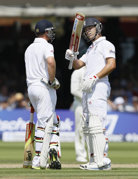 England's Jonathan Trott talks with Ian Bell as he acknowledges applause for scoring 50 during the Ashes test at Lord's cricket ground in London.