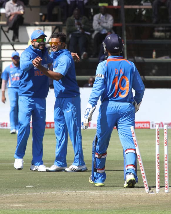 Indian players celebrate the wicket of Zimbabwe's Sean Williams during the one day international in Harare.