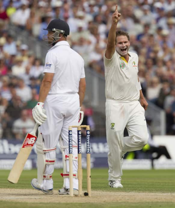 Australia's Ryan Harris celebrates after taking the wicket of England's Jonathan Trott on the third day of the third Ashes Test series cricket match at Old Trafford cricket ground, Manchester, England.