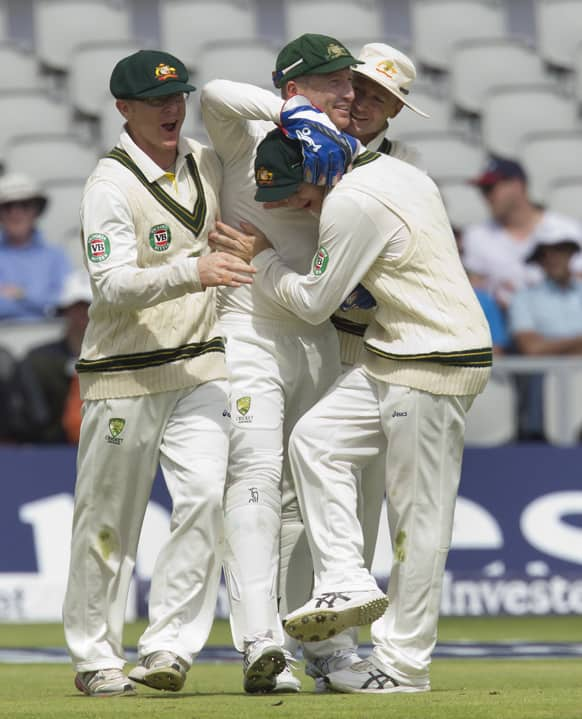 Australia's Brad Haddin celebrates with teammates after catching England's Alastair Cook for 62 of the bowling of Mitchell Starc on the third day of the third Ashes Test series cricket match at Old Trafford cricket ground.