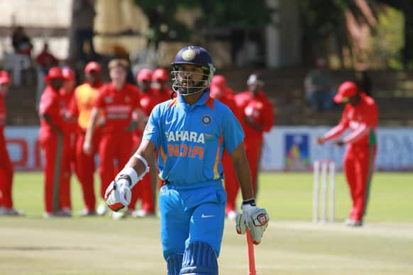 Shikhar Dhawan walks off the pitch after been dismissed during the last day of a series of one day international cricket match between India and Zimbabwe at the Queens Sports Club in Bulawayo, Zimbabwe.