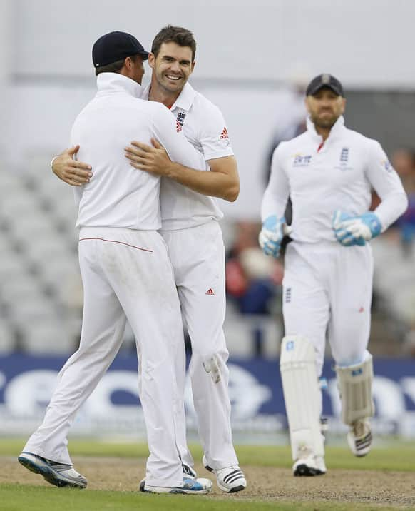 England's James Anderson, centre, embraces Graeme Swann to celebrate the wicket of Australia's Brad Haddin during day four of the third Ashes Test match held at Old Trafford cricket ground in Manchester.