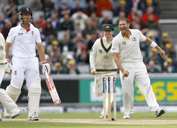 Australia's Ryan Harris, right, celebrates the wicket of England's Jonathan Trott, left, during day five of the third Ashes Test match held at Old Trafford cricket ground in Manchester