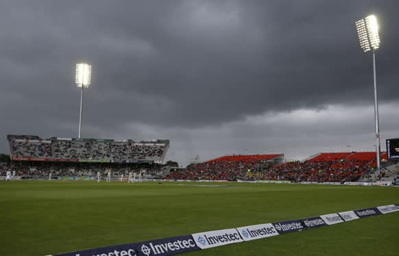 England plays Australia as rain clouds hang over the ground during day five of the third Ashes Test match held at Old Trafford cricket ground in Manchester, England.