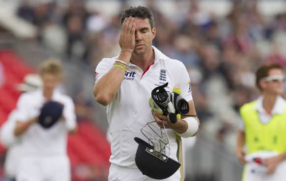 England's Kevin Pietersen reacts after an unsuccessful decision review as he walks from the pitch after losing his wicket, caught by Brad Haddin for 8 off the bowling of Australia's Peter Siddle, on the final day of the third Ashes Test series cricket match at Old Trafford cricket ground, Manchester